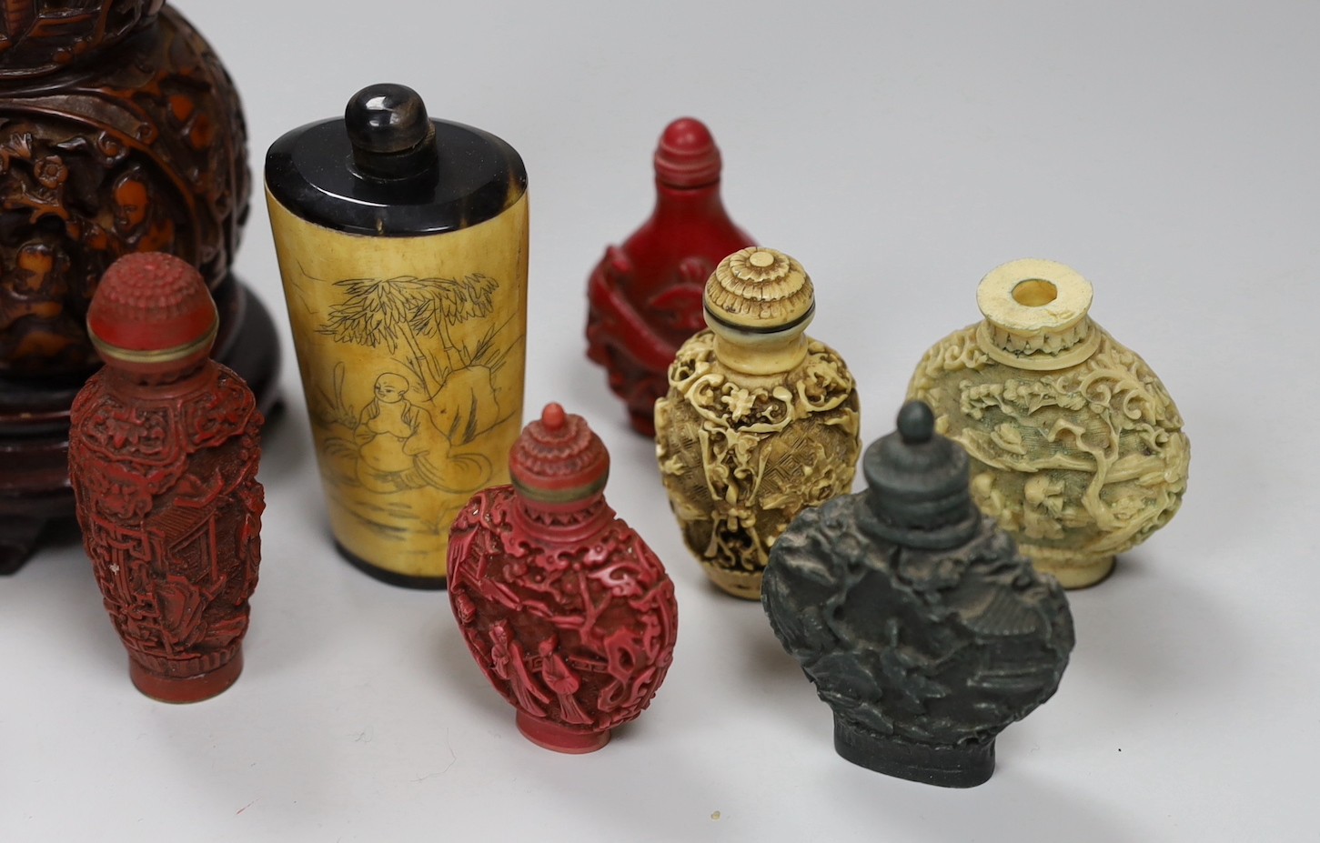 A large Chinese 20th century carved snuff bottle and smaller snuff bottles, all resin